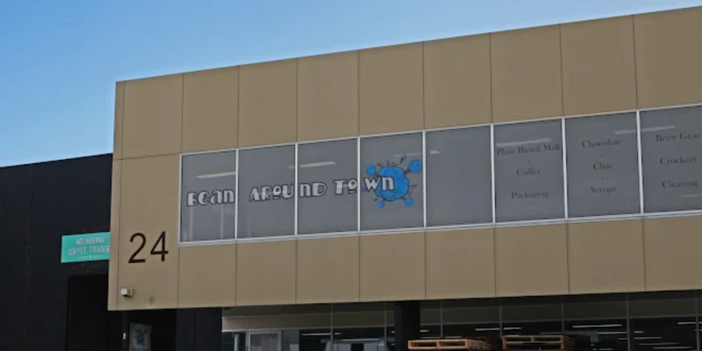 A large building with a sign reading "24," indicating it is a coffee bean supplier.