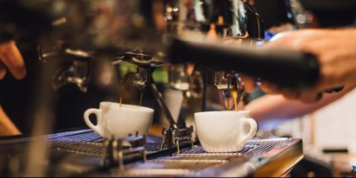 A person pours coffee from a pot into a cup, highlighting the importance of quality coffee equipment for businesses.