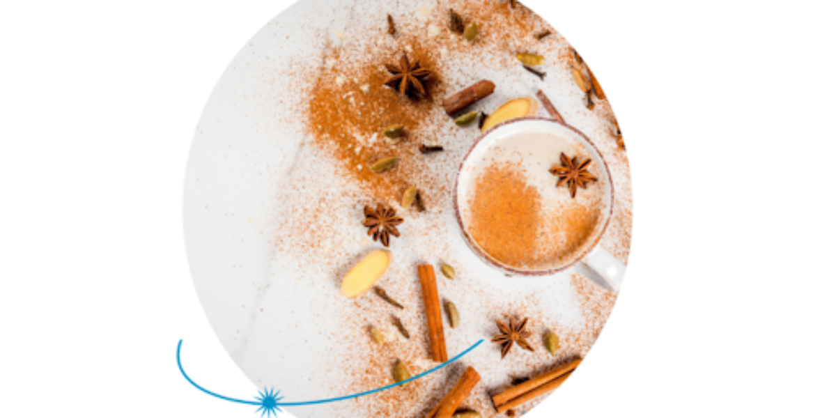 A bowl of various spices on a white background, essential for creating a flavorful chai latte.